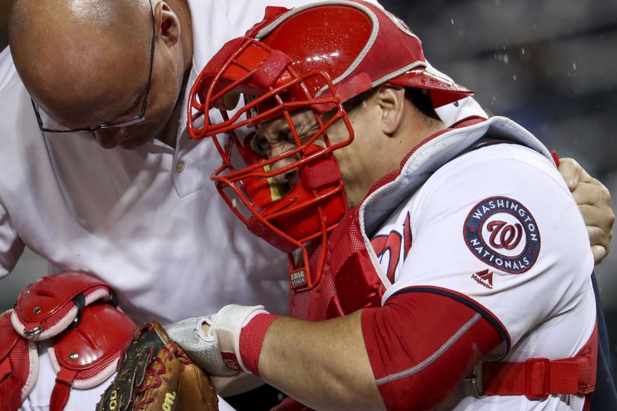 In this photo taken Sept. 26, 2016, Washington Nationals catcher Wilson Ramos (40) goes down with a knee injury during the 6th inning of a baseball game between the Washington Nationals and the Arizona Diamondbacks at Nationals Park in Washington. Most major league teams deal with injuries of some significance at some point in the season, from spring training right down to September. Covering those holes in the playoffs can be a big deal _ or can create opportunities for a relatively unknown player to move into the limelight and succeed. (AP Photo/Andrew Harnik)