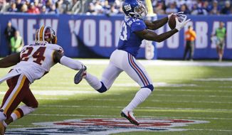 FILE - In this Sunday, Sept. 25, 2016, file photo, New York Giants wide receiver Odell Beckham (13) catches a pass in front of Washington Redskins&#39; Josh Norman (24) during the second half of an NFL football game in East Rutherford, N.J. Maybe Beckham will start making headlines again for his receiving talents when the Giants visit the Green Bay Packers on Sunday night.Because this week, the chatter around the league about Beckham has mainly been about the wideout’s tantrums. (AP Photo/Kathy Willens, File)