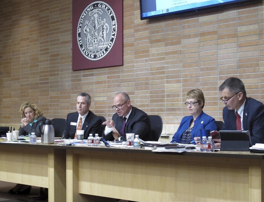 Wyoming Gov. Matt Mead, center, asks questions about loan applications during a State Loan and Investment Board meeting in Cheyenne, Wyo., on Thursday, Oct. 6, 2016. Board members, from left, State Superintendent of Public Instruction Jillian Balow, Secretary of State Ed Murray, Gov. Mead, State Auditor Cynthia Cloud, and State Treasurer Mark Gordon. (AP Photo/Ben Neary)