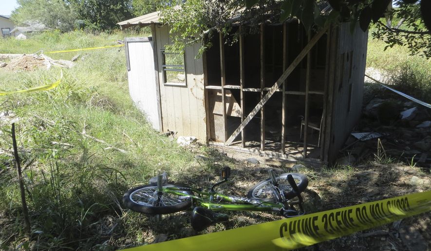 Police tape blocks of the location of a fire on Wednesday, Oct. 5, 2016 in Kerrville, Texas. A Texas juvenile has been charged with arson after police say he tossed aside a burning gas canister that struck and seriously burned a 10-year-old boy. City officials in Kerrville, 70 miles northwest of San Antonio, said in a statement Wednesday that the juvenile is "responsible for causing the victim's severe burns." Officials haven't released the identity of the juvenile, who is charged with first-degree arson. (Zeke MacCormack/The San Antonio Express-News via AP)