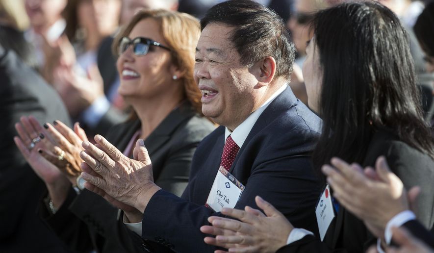 Cho Tak Wong, chairman of the Fuyao Group, applauds during the grand opening of the Fuyao Glass America plant, Friday, Oct. 7, 2016, in Moraine, Ohio. The Chinese company is ready to show off its completed automotive glass-making plant in Ohio, which serves as its North American hub for recycled glass manufacturing. (AP Photo/John Minchillo)