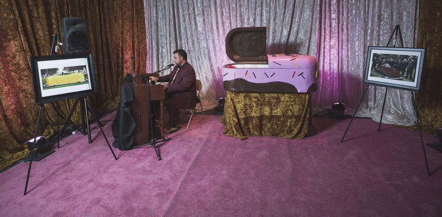 This Oct. 4, 2016 photo provided by Creative Time shows a scene from a satirical performance-based installation called “Doomocracy” or “The Haunted House of Political Horrors,” in the Brooklyn borough of New York. The theatrical experience at the sprawling Brooklyn Army Terminal is timed for both the elections and Halloween and includes this room which simulates a funeral parlor complete with a child-sized coffin, and an organist playing junk-food jingles in the background. (Will Star/Creative Time via AP)