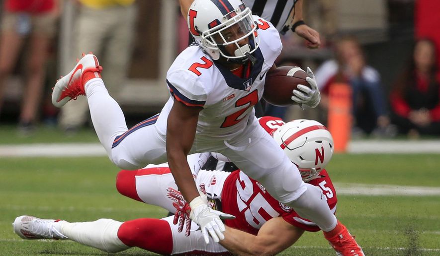FILE - In this Oct. 1, 2016, file photo, Illinois running back Reggie Corbin (2) is tripped up by Nebraska safety Nate Gerry (25) during an NCAA college football game in Lincoln, Neb. When Lovie Smith took the head coaches’ job at Illinois, he said his team would run the ball. Corbin had 9 carries for 72 yards against the Cornhuskers, and with a Purdue team that gave up 400 yards on the ground last week to Maryland up next, the work-in-progress Illini ground game could soon look much better. (AP Photo/Nati Harnik, File)