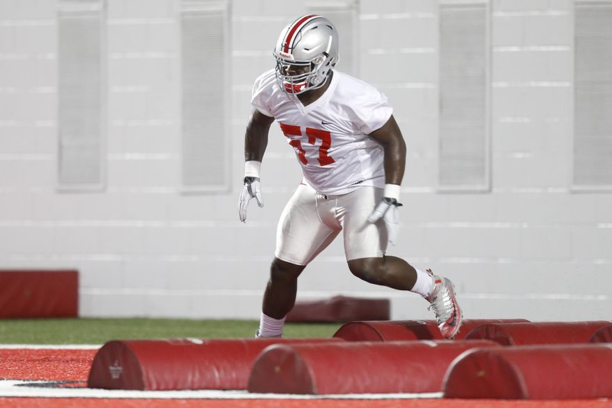 FILE - In this March 8, 2016, file photo, Ohio State defensive tackle Robert Landers runs drills during their Spring NCAA college football practice in Columbus, Ohio. Among the many pleasant surprises for Ohio State this season is an undersized redshirt freshman named Landers. (AP Photo/Jay LaPrete, File)