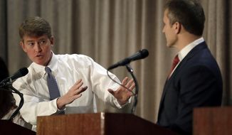 FILE - In this Sept. 30, 2016 file photo, Democratic gubernatorial candidate Chris Koster, left, speaks to Republican challenger Eric Greitens during the first general election debate in the race for Missouri governor in Branson, Mo. During the debate, Greitens accused Koster of wanting to have Darren Wilson, the Ferguson police officer who shot and killed Michael Brown, fired or forced to resign before all the facts were in. (AP Photo/Jeff Roberson, File)