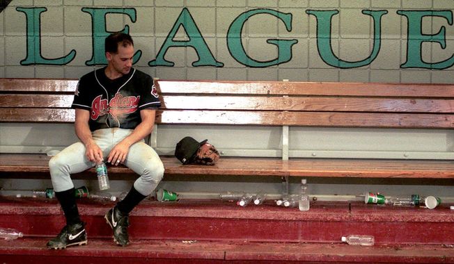 FILE - In this Oct. 27, 1997, file photo, Cleveland Indians shortstop Omar Vizquel sits dejectedly in the dugout after the Indians lost to the Marlins 3-2 in Game 7 of the baseball World Series at Pro Player Stadium in Miami.  (Roadell Hickman/The Cleveland Plain Dealer via AP, File)