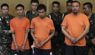 Suspected Muslim extremists, from left in front row, Wendel Apostol Facturan, Musali Mustapha and TJ Tagdaya Macabalang are presented to reporters at Camp Aguinaldo military headquarters in Quezon city, north of Manila, Philippines Friday, Oct. 7, 2016. Philippine troops have captured the three suspects in the bombing of a night market that killed 15 people and seized a cellphone video of the blast from them that they apparently took for propaganda purposes, the defense chief said Friday. (AP Photo/Aaron Favila)