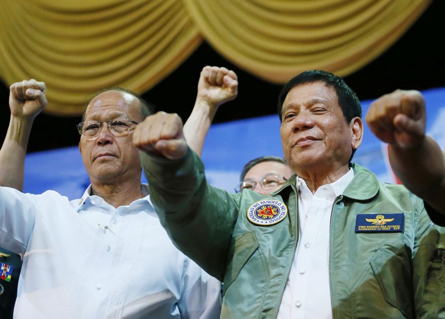 In this Sept. 13, 2016, file photo, Philippine President Rodrigo Duterte, center, poses with a fist bump with Defense Chief Delfin Lorenzana, left, during his &amp;quot;Talk with the Airmen&amp;quot; on the anniversary of the 250th Presidential Airlift Wing, at the Philippine Air Force headquarters in suburban Pasay city, southeast of Manila, Philippines. (AP Photo/Bullit Marquez, File)