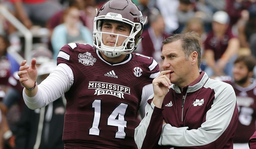 FILE - In this April 16, 2015, file photo, Mississippi State Maroon squad quarterback Nick Tiano (14) confers with coach Dan Mullen during the second half of a spring NCAA college football game, in Starkville, Miss. Recruiting analysts say it’s tougher to project which top prospects will succeed in college at quarterback than at any other position. “What you don’t see on film is leadership,” Mississippi State coach Dan Mullen said. “It’s hard to evaluate the processing of information and intelligence because a lot of times you don’t know what they’re being coached to do (in high school).” (AP Photo/Rogelio V. Solis, File)