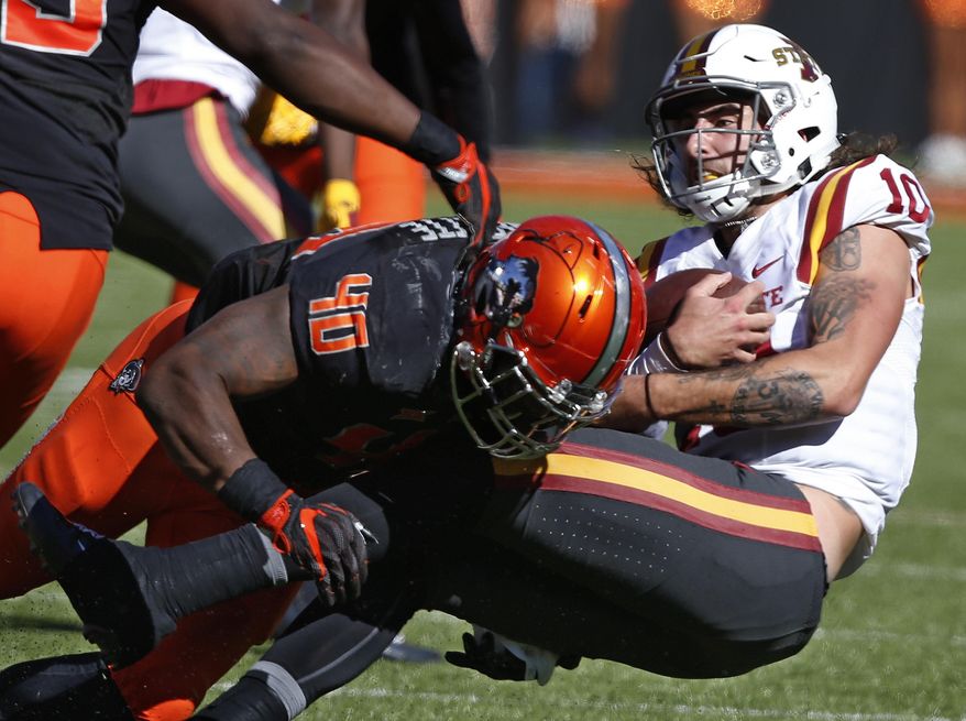 Iowa State quarterback Jacob Park (10) is tackled by Oklahoma State linebacker Devante Averette (40) in the second quarter of an NCAA college football game in Stillwater, Okla., Saturday, Oct. 8, 2016. (AP Photo/Sue Ogrocki)