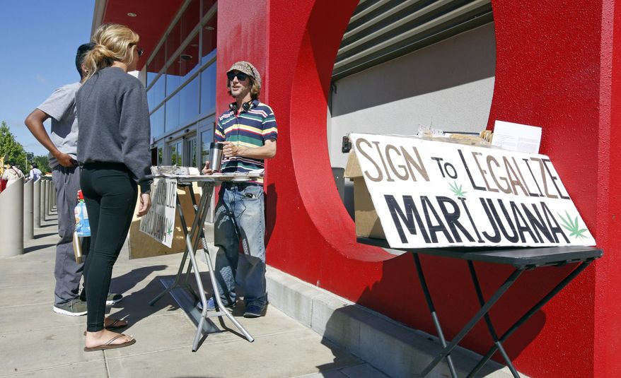 FILE - In this Saturday April 23, 2016, file photo, petition signature gatherer Peter Keyes, right, discusses a petition to legalize marijuana in Sacramento, Calif. For the second time in six years, California voters are being asked to legalize the recreational use of marijuana. This time, supporters of the move have much more financial backing and professional campaign help than they did in 2010. Polls show Proposition 64 with more than the 50 percent of voter support needed to pass. (AP Photo/Rich Pedroncelli, File)