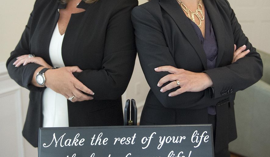 ADVANCE FOR THE WEEKEND OF OCT. 8-9 AND THEREAFTER - In a Tuesday, Sept. 13, 2016 photo, Catherine Shanahan and Karen Chellew , pose for a photo at their office in Middletown Township, Pa. Shanahan, a financial adviser specializing in divorce, left, has partnered with attorney Karen Chellew, right, to create Divorce U Solutions. (Chloe Elmer/Bucks County Courier Times via AP)
