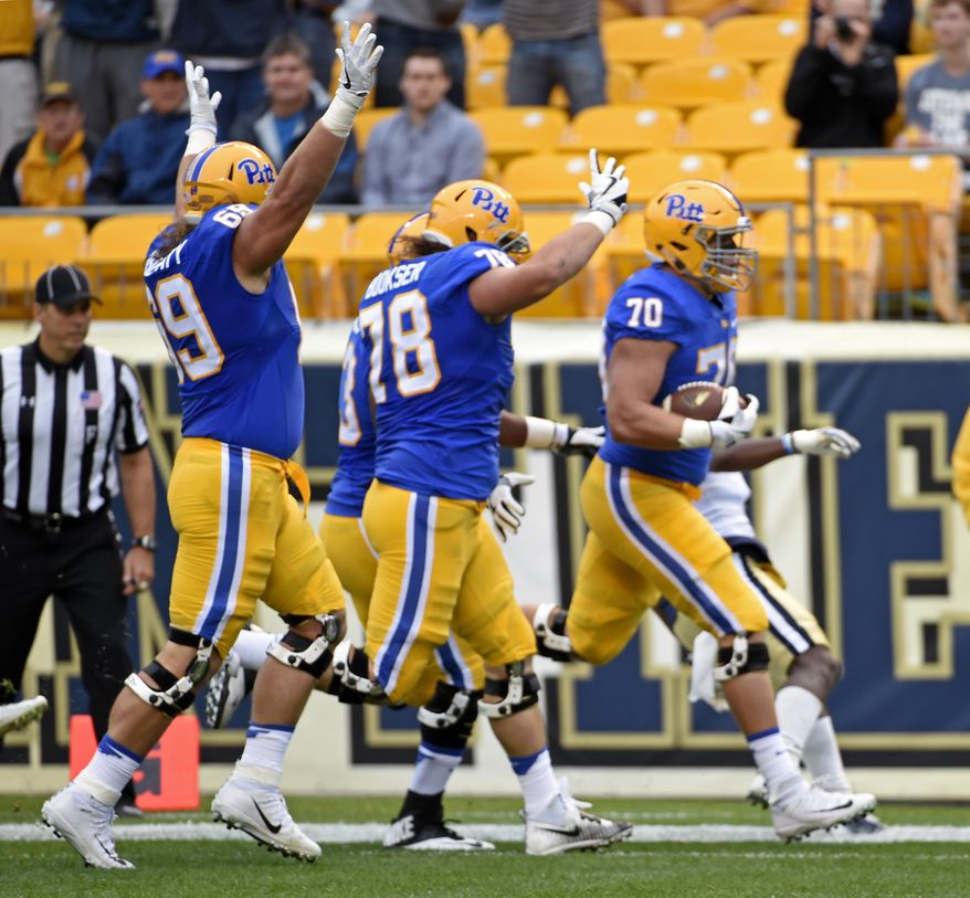Pittsburgh's Adam Bisnowaty (69) and Alex Bookser (78) celebrate as offensive lineman Brian O'Neill (70) scores a touchdown during the first half of an NCAA college football game against Georgia Tech in Pittsburgh, Saturday, Oct. 8, 2016. (AP Photo/Fred Vuich)