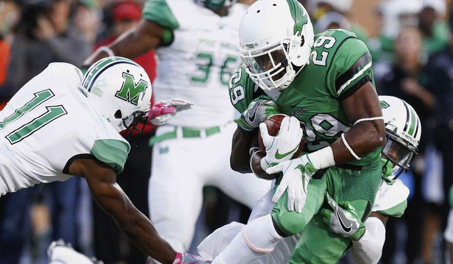 North Texas running back Willy Ivery (29) rushes the ball, while Marshall safety C.J. Reavis (1) wraps him from behind in an NCAA college football game in Denton, Texas, Saturday, Oct. 8, 2016. (Jeff Woo/The Denton Record-Chronicle via AP)