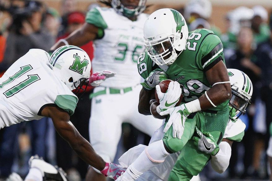 North Texas running back Willy Ivery (29) rushes the ball, while Marshall safety C.J. Reavis (1) wraps him from behind in an NCAA college football game in Denton, Texas, Saturday, Oct. 8, 2016. (Jeff Woo/The Denton Record-Chronicle via AP)