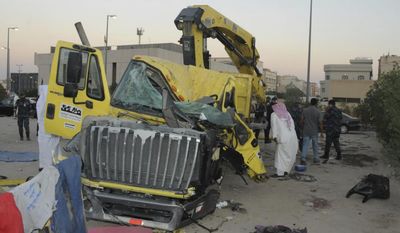 In this Saturday Oct. 8, 2016 photo released by Kuwait Ministry of Interiors, a damaged garbage truck after it rammed into another truck carrying five U.S. soldiers in Kuwait. An Egyptian driving a garbage truck loaded with explosives and Islamic State papers rammed into a truck carrying five U.S. soldiers in Kuwait on Saturday, injuring only himself in the attack, authorities said. (Kuwait Ministry of Interiors via AP)