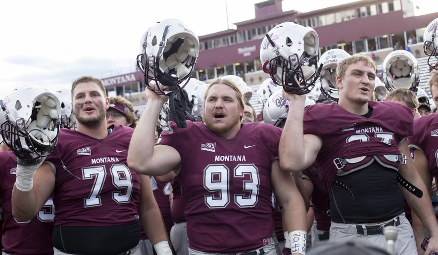 Montana players sing their fight song to the crowd after defeating Mississippi Valley State in an NCAA college football game Saturday, Oct. 8, 2016, in Missoula, Mont. (AP Photo/Patrick Record)