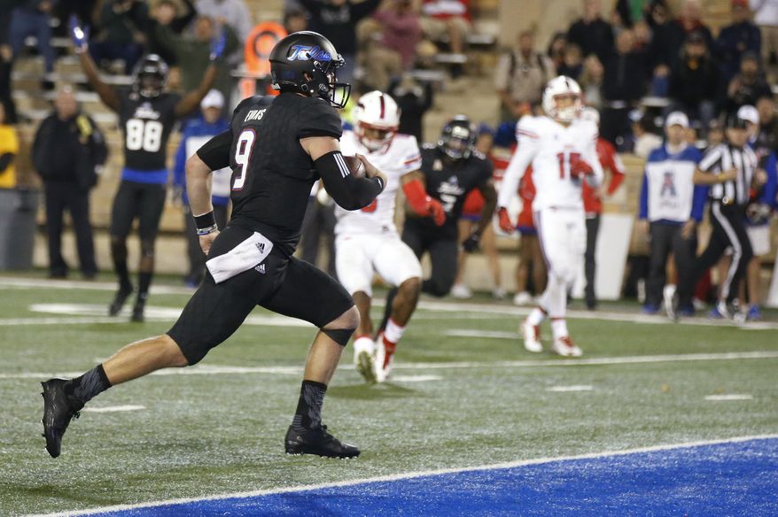 Tulsa quarterback Dane Evans (9) runs into the end zone with the game-winning touchdown in overtime of an NCAA college football game against SMU in Tulsa, Okla., Friday, Oct. 7, 2016. Tulsa won 43-40. (AP Photo/Sue Ogrocki)
