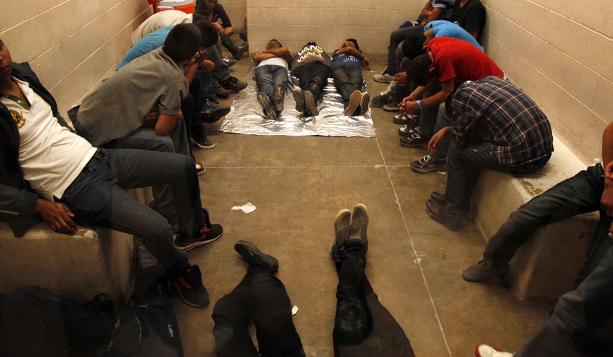 FILE - In this Tuesday, July 15, 2014, file photo, More than 350 immigrants who have been detained while crossing the border are held inside the McAllen Border Patrol Station in McAllen, Texas. Barely half of immigrants who entered the country illegally on the U.S. border with Mexico last year got caught. That's according to an internal Department of Homeland Security report obtained by The Associated Press, Thursday, Oct. 6, 2016. (AP Photo/Los Angeles Times, Rick Loomis, Pool, File)