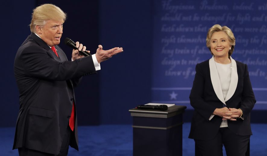 Donald Trump speaks with Hillary Clinton on Sunday during the second presidential debate at Washington University in St. Louis. (Associated Press)
