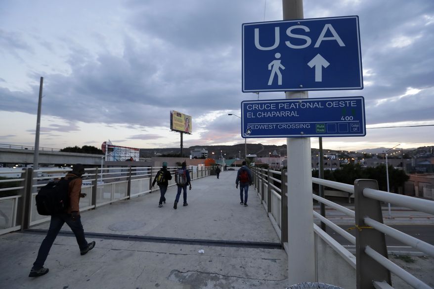 In this Sept. 27, 2016, photo, Haitians make their way towards the border crossing in Tijuana, Mexico. U.S. officials say about 5,000 Haitians showed up at San Ysidro from October 2015 through late last month, and Immigration and Customs Enforcement Director Sarah Saldana said at a recent congressional hearing that officials told her on a trip to Central America that 40,000 more were on their way. (AP Photo/Gregory Bull)