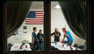 ADVANCE FOR USE SUNDAY, OCT. 9 - In this Monday, Sept. 26, 2016 photo, from left, Matthew Logue, 12 of Ponca, Gabe Reinert, 13, of Martinsburg, and  Michaela Nitz, of Dixon County, listen as hunting education instructor Alex Thomas leads a hands-on demonstration during a hunting education class in Martinsburg, Neb. (Justin Wan/Sioux City Journal via AP)