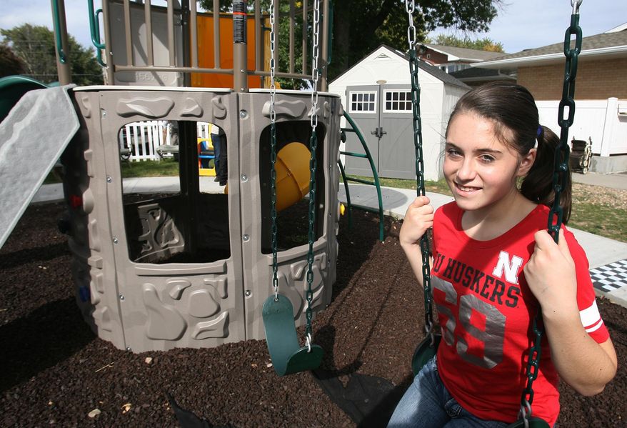 ADVANCE FOR SUNDAY, OCT. 9, 2016 - In this Sept. 30, 2016 photo, Jadyn Shoemaker poses at the new playground at the Crossroads Center Rescue Mission, in Hastings, Neb. The playground is the result of Shoemaker's inspiration and fundraising efforts. (Amy Roh/The Hastings Tribune via AP)