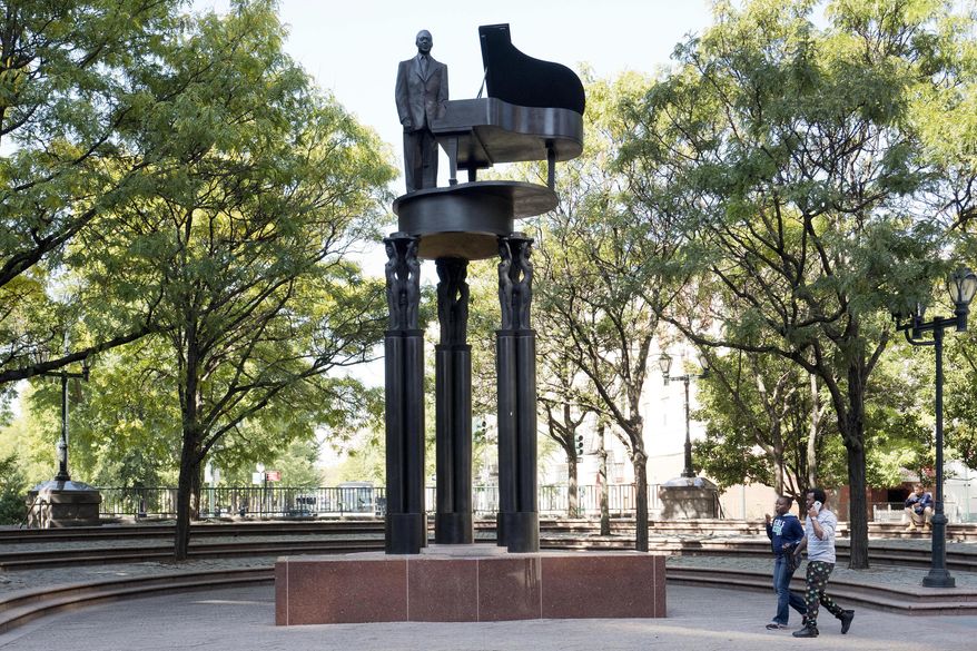 In this Thursday, Oct. 6, 2016 photo, a statue of jazz great Duke Ellington with a piano is located at an entrance to New York's Central Park. In Central Park, none of the sculptures or busts honoring illustrious people is a woman. Now, activists are raising money to erect the park’s first monument to women who changed history: suffragettes Elizabeth Cady Stanton and Susan B. Anthony. (AP Photo/Mark Lennihan)