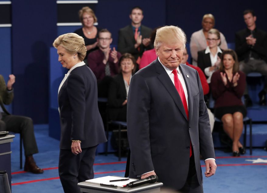 Democratic presidential nominee Hillary Clinton, left, and Republican presidential nominee Donald Trump arrive before the second presidential debate at Washington University in St. Louis, Sunday, Oct. 9, 2016. (Rick T. Wilking/Pool via AP)
