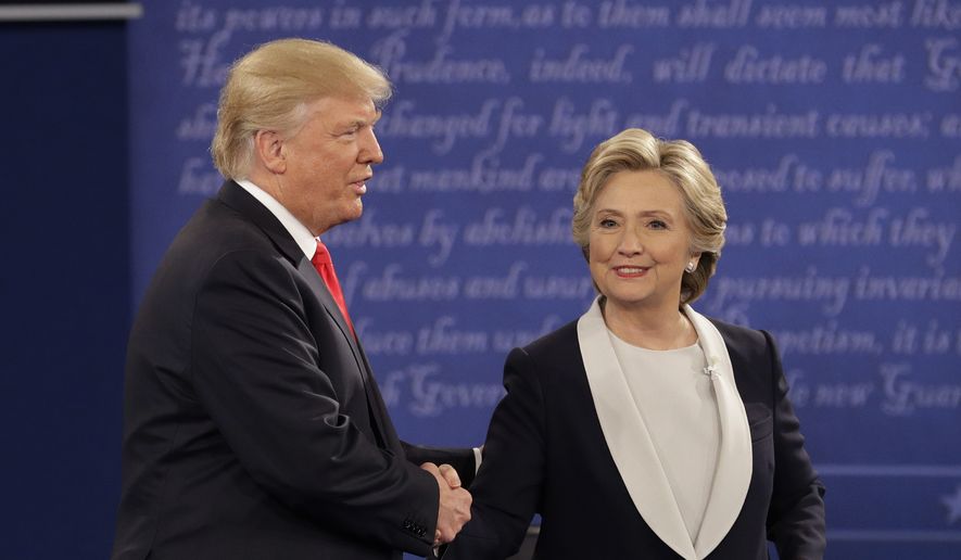 Republican presidential nominee Donald Trump shakes hands with Democratic presidential nominee Hillary Clinton during the second presidential debate at Washington University in St. Louis, Sunday, Oct. 9, 2016. (AP Photo/John Locher) ** FILE **