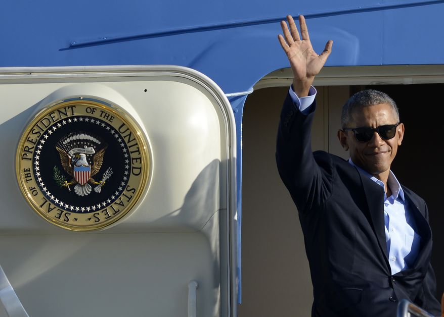 President Barack Obama waves while boarding Air Force One before leaving O'Hare International Airport Sunday, Oct. 9, 2016, in Chicago. (AP Photo/Paul Beaty)