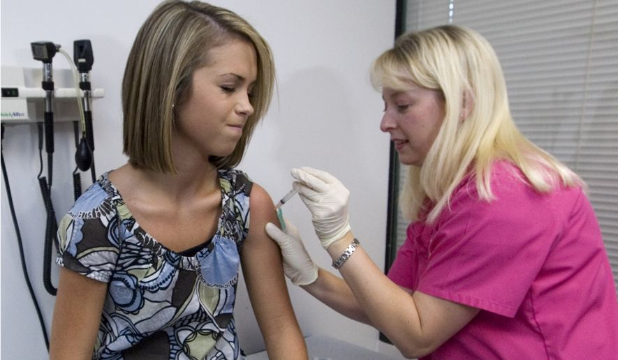 Lauren Fant winces as she has her third and final application of the human papillomavirus (HPV) vaccine administered by nurse Stephanie Pearson at a doctor&#39;s office in Marietta, Georgia, on Dec. 18, 2007. (Associated Press) **FILE**