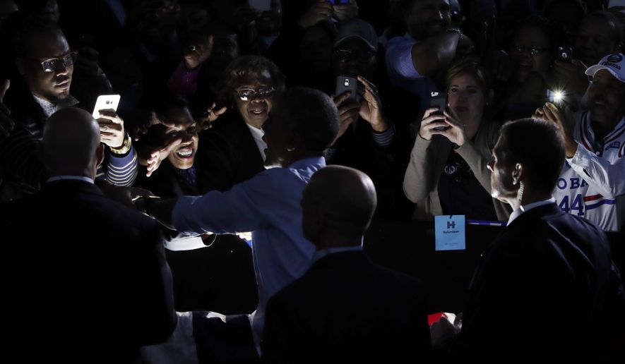 President Barack Obama greets people in the audience after speaking at a campaign event for Democratic presidential candidate Hillary Clinton at the White Oak Amphitheatre in Greensboro, N.C., Tuesday, Oct. 11, 2016. (AP Photo/Carolyn Kaster)