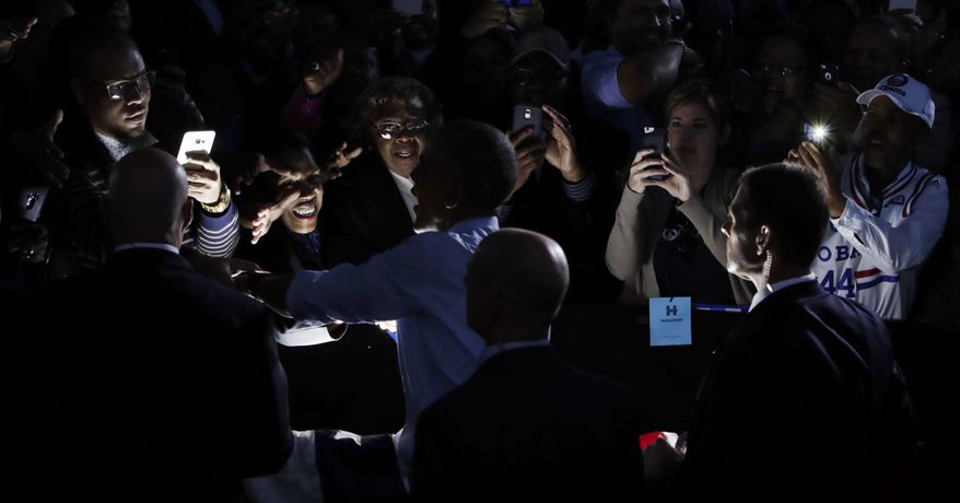 President Barack Obama greets people in the audience after speaking at a campaign event for Democratic presidential candidate Hillary Clinton at the White Oak Amphitheatre in Greensboro, N.C., Tuesday, Oct. 11, 2016. (AP Photo/Carolyn Kaster)
