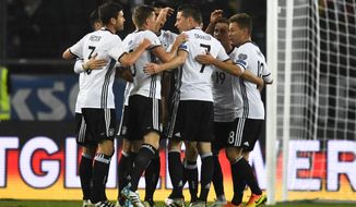CAPTION CORRECTS THE NAME - Germany’s Julian Draxler, center with 7, celebrates with team mates after scoring his side’s opening goal during the World Cup Group C qualifying soccer match between Germany and Northern Ireland in Hannover, Germany, Tuesday, Oct. 11, 2016. (AP Photo/Martin Meissner)