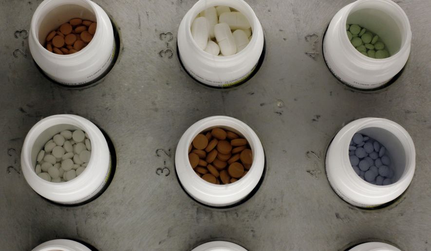 In this June 14, 2011 file photo, various prescription drugs on the automated pharmacy assembly line at Medco Health Solutions in Willingboro, N.J.  (AP Photo/Matt Rourke, File) **FILE**