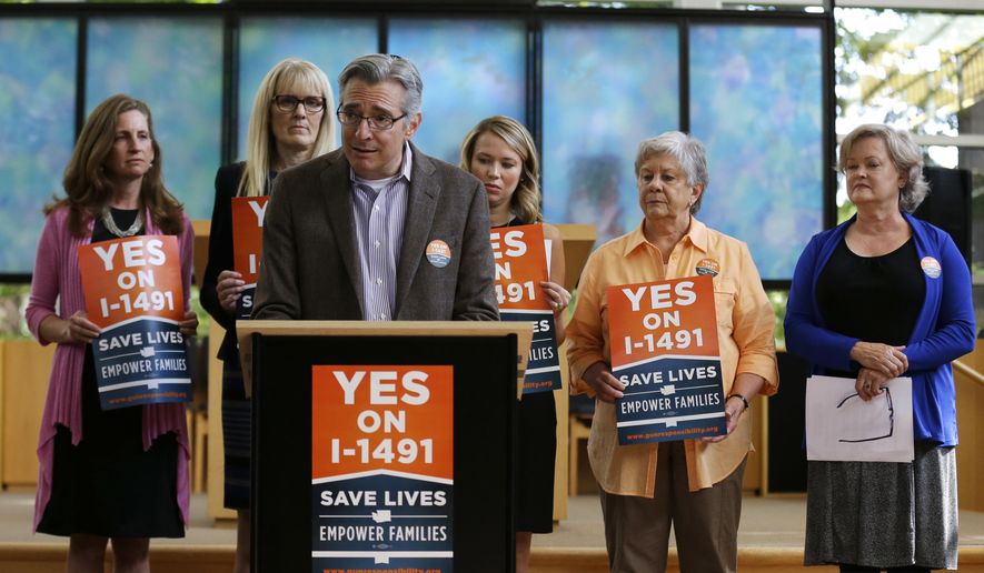 In this photo taken Sept. 21, 2016, Daniel Weiner, center, Senior Rabbi at Temple De Hirsch Sinai in Bellevue, Wash., speaks at news conference in Bellevue promoting Initiative 1491, which will be on the ballot in the November elections. If passed by voters, the initiative would allow law enforcement or others to obtain court orders to temporarily take guns from people considered a danger to themselves or others. Weiner is a founding member of the Washington Alliance for Gun Responsibility. (AP Photo/Ted S. Warren)