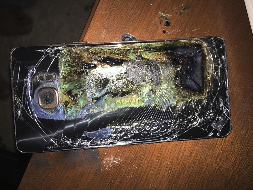 This Sunday, Oct. 9, 2016, photo shows a damaged Samsung Galaxy Note 7 on a table in Richmond, Va., after it caught fire earlier in the day. Samsung Electronics said Tuesday, Oct. 11, that it is discontinuing production of Galaxy Note 7 smartphones permanently, a day after stopping global sales of the ill-fated devices. (Shawn L. Minter via AP)