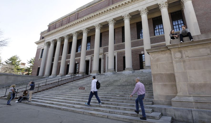People gather in front of Widener Library on the campus of Harvard University in Cambridge, Mass. (Associated Press)