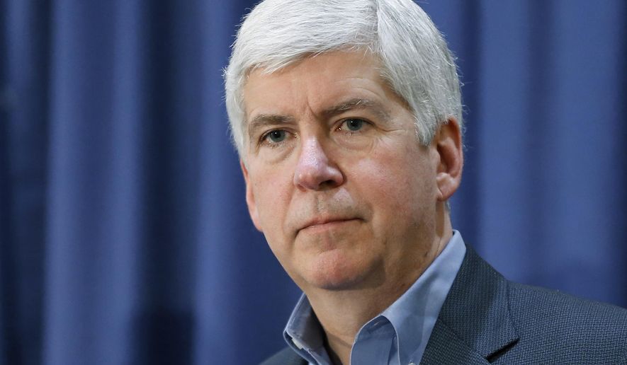 FILE - In this Feb. 26, 2016, file photo, Michigan Gov. Rick Snyder listens to a question after attending a Flint Water Interagency Coordinating Committee meeting in Flint, Mich. A Flint resident filed a complaint Tuesday, Oct. 11, 2016, asking for a grand jury investigation of Snyder’s decision to use at least $2 million in state funds for his legal representation related to criminal probes of the city’s water crisis. The complaint alleges that the governor broke the law by violating conflict-of-interest prohibitions and “unilaterally” spending taxpayer money for personal benefit without the authority to do so. (AP Photo/Paul Sancya, File)