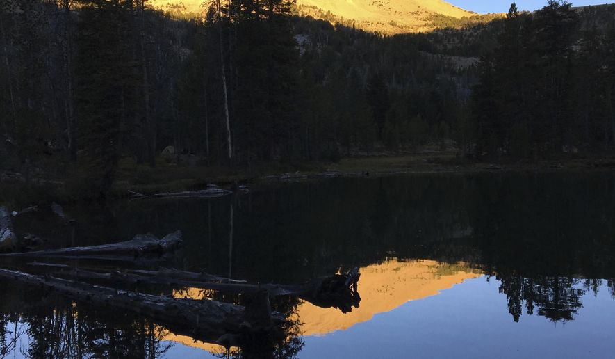 ADVANCE FOR THE WEEKEND OF OCT. 15-16 AND THEREAFTER - In a Sept. 11, 2016 photo,the rising sun illuminates a peak over Washington Lake northeast of Sun Valley, Idaho, in the White Cloud Mountains. (Scott McIntosh/Idaho Press Tribune via AP)