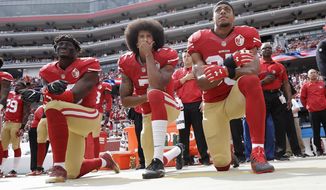 In this Oct. 2, 2016 file photo, from left, San Francisco 49ers outside linebacker Eli Harold, quarterback Colin Kaepernick and safety Eric Reid kneel during the national anthem before an NFL football game against the Dallas Cowboys in Santa Clara, Calif. A new poll shows that most white Americans disapprove of athletes protesting during the playing of “The Star-Spangled Banner.”  (AP Photo/Marcio Jose Sanchez, File)