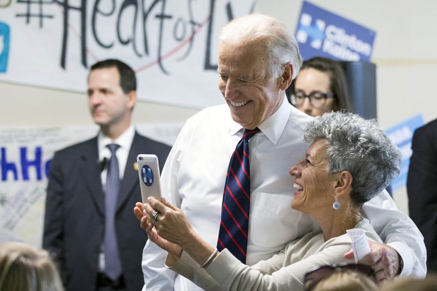 Vice president Joe Biden takes a photo with a supporter at a Democratic coordinated field office during an unscheduled stop at W. Sahara Avenue Thursday, Oct. 13, 2016, in Las Vegas. (Erik Verduzco/Las Vegas Review-Journal via AP)