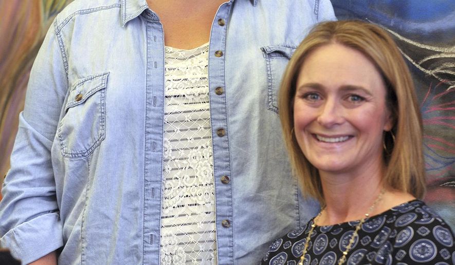 ADVANCE FOR USE SATURDAY, OCT. 15, 2016 AND THEREAFTER - In this Sept. 27, 2016 photo, parents Inga Harty, left, and Marji Boeye, pose for a photo in Rock Island, Ill. A grassroots effort launched by the two moms in the Rock Island-Milan School District has resulted in suicide awareness programming for all grade levels, community outreach, and a successful fundraising campaign that will pave the way for future initiatives. (Gary Krambeck/The Dispatch via AP)