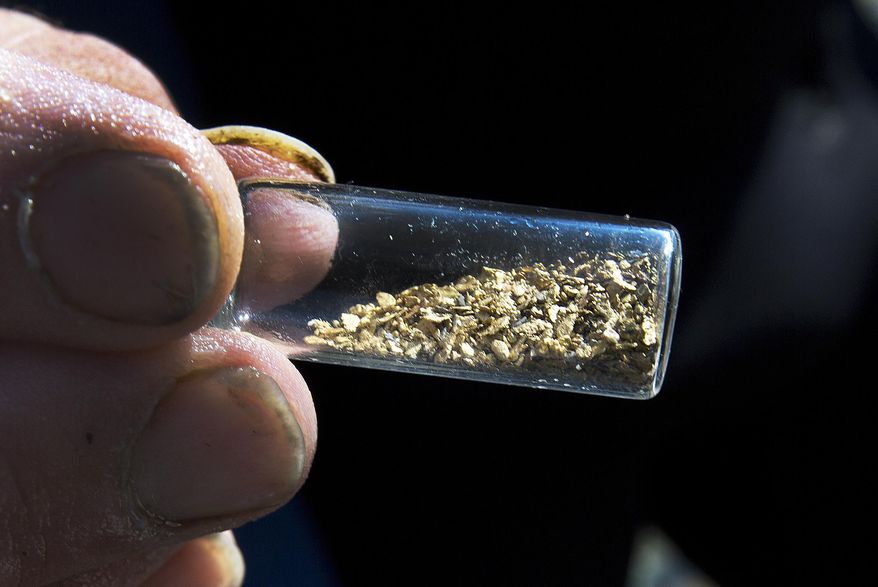 In this Sunday, Sept. 4, 2016, photo, Chris Hall shows off a vile of gold he's mined from the Wild Ammonoosuc River in Bath, N.H. A new generation of gold miners is giving prospecting a try, especially in New England and the Pacific Northwest. The growth is attributed partially to television shows like "Yukon Gold." (AP Photo/Jim Cole)