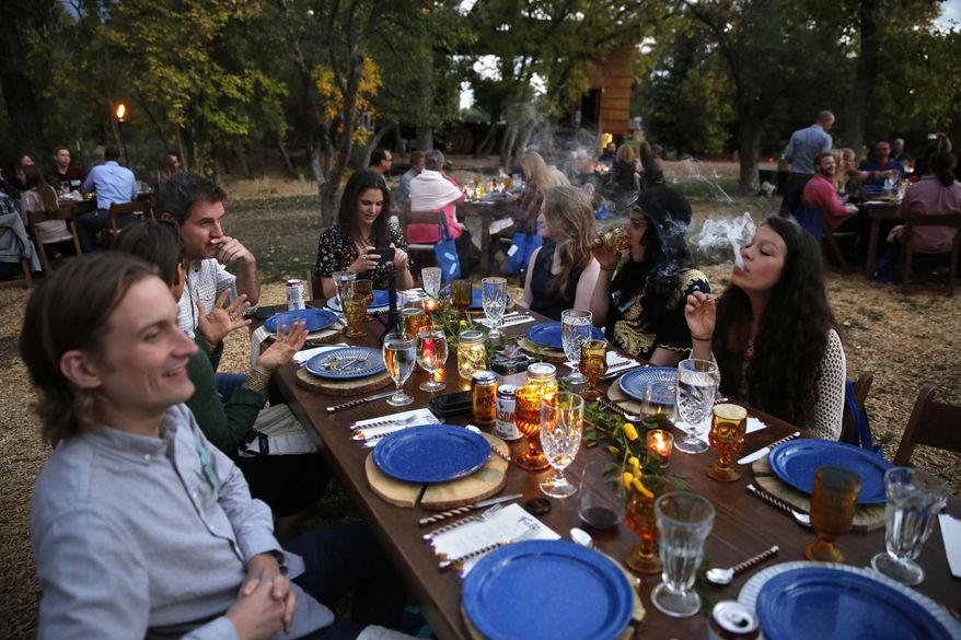 In this Oct. 2, 2016 photo, diners smoke marijuana as they eat dishes prepared by chefs during an evening of pairings of fine food and craft marijuana strains served to invited guests dining at Planet Bluegrass, an outdoor venue in Lyons, Colo. Chefs and pot growers trying to explore fine dining with weed face a legal gauntlet to make pot dinners a reality, even where the drug is legal. (AP Photo/Brennan Linsley)