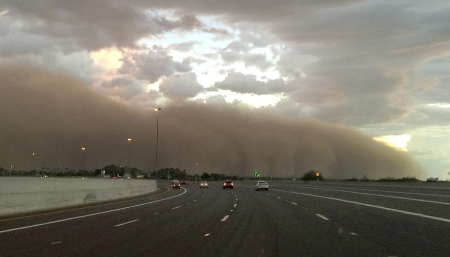 FILE - In this Sept. 6, 2014 file photo, a wall of dust moves across a freeway in Phoenix. Arizona Department of Transportation engineers are beginning design work on a dust detection and warning system for Interstate 10 between Tucson and Phoenix where dust storms often develop suddenly. (AP Photo/Katie Oyan, File)