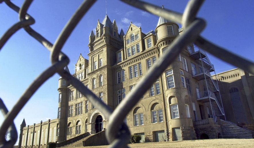 FILE - In this January 2001 file photo, the old Tennessee State Penitentiary is seen through a fence in Nashville, Tenn. The state Department of Correction on Oct. 12, 2016, posted a video featuring drone footage of the crumbling facility that was shuttered in 1992 and was once a favorite film location. (AP Photo/Mark Humphrey, file)
