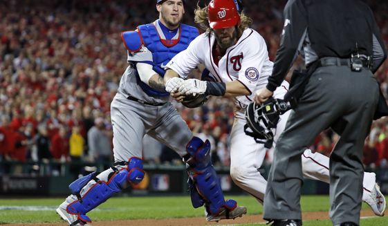 Washington Nationals&#39; Jayson Werth is tagged out at home by Los Angeles Dodgers catcher Yasmani Grandal during the sixth inning during Game 5 of a baseball National League Division Series, at Nationals Park, Thursday, Oct. 13, 2016, in Washington, as home plate umpire Jeff Kellogg watches. The Dodgers won 4-3. (AP Photo/Alex Brandon)