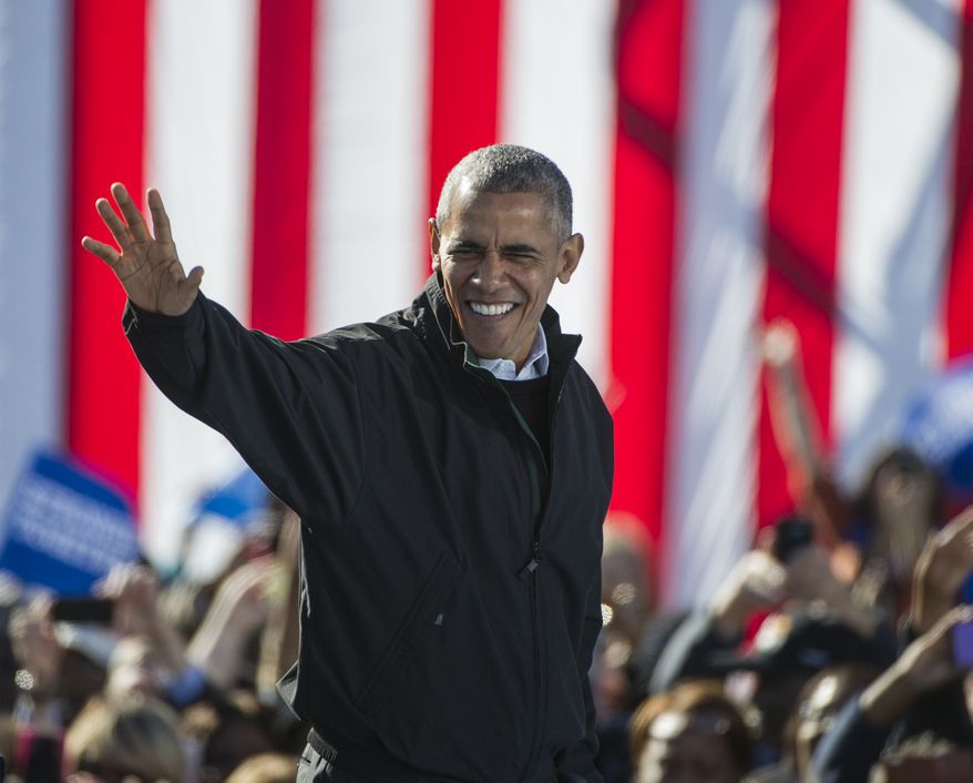 President Barack Obama walks on stage before delivering a speech to support Democratic presidential candidate Hillary Clinton at Burke Lakefront Airport in Cleveland, Friday, Oct. 14, 2016. (AP Photo/Phil Long) ** FILE **